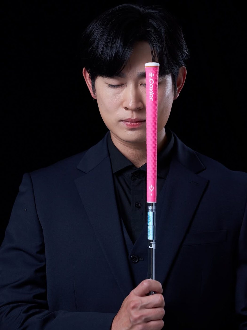 검은 정장 차림으로 분홍 그립을 든 박기태